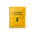 Yellow package of Dailymade Caramel Popcorn on a white background