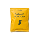 Yellow package of Dailymade Caramel Popcorn on a white background