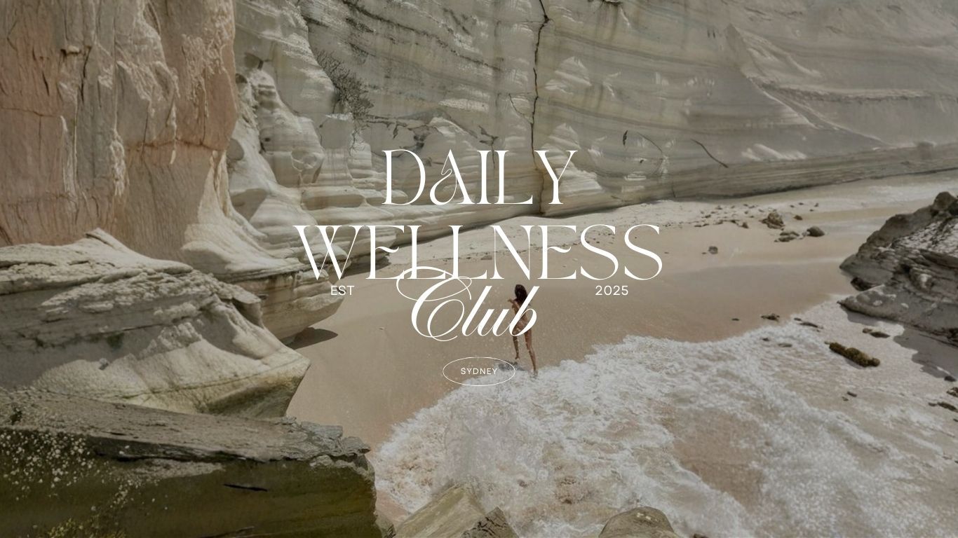 Beach scene with rocky cliffs and 'Daily Wellness Club' text overlay