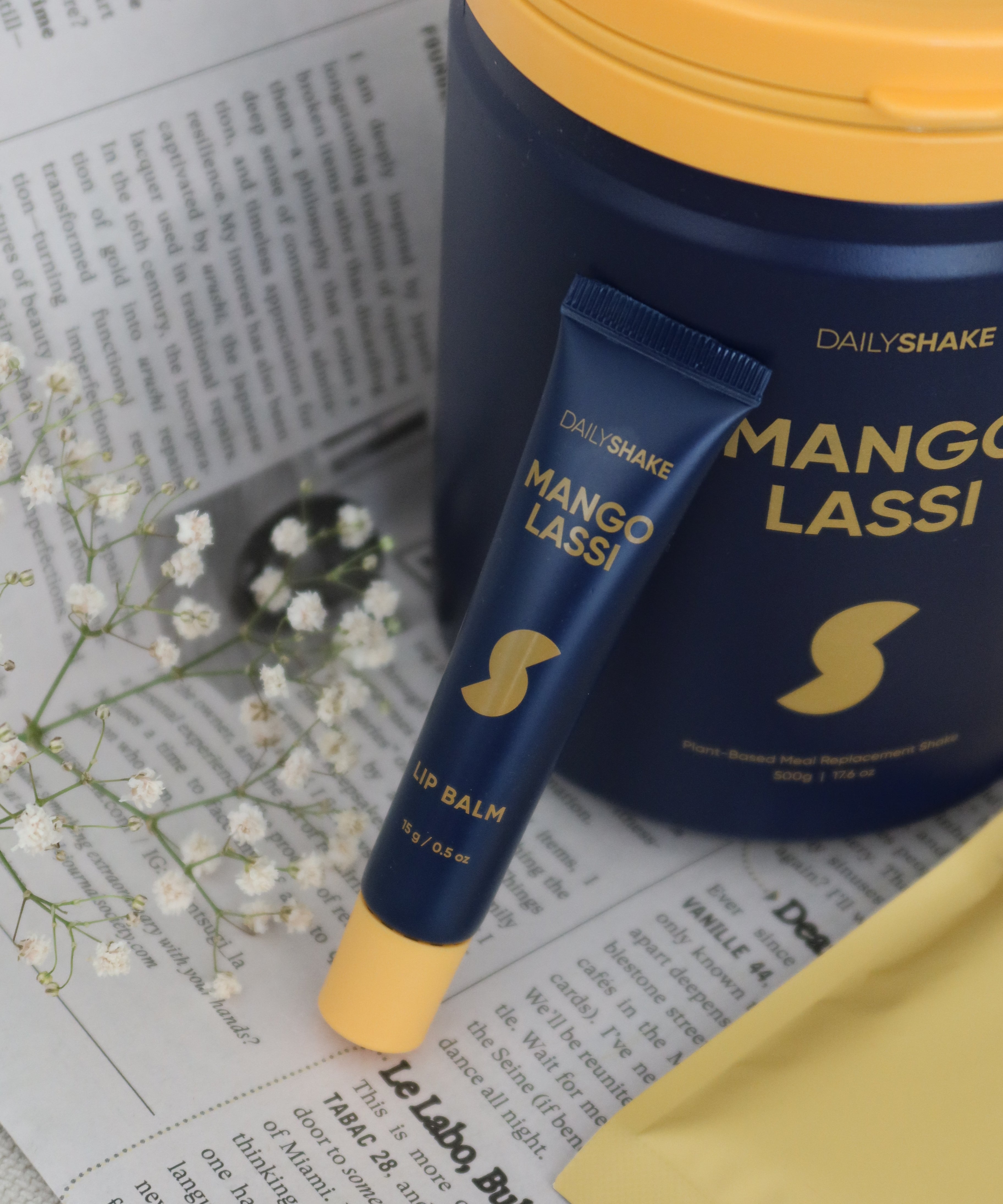 Blue and yellow 'Dala Shake Mango Lassi' product on a newspaper background